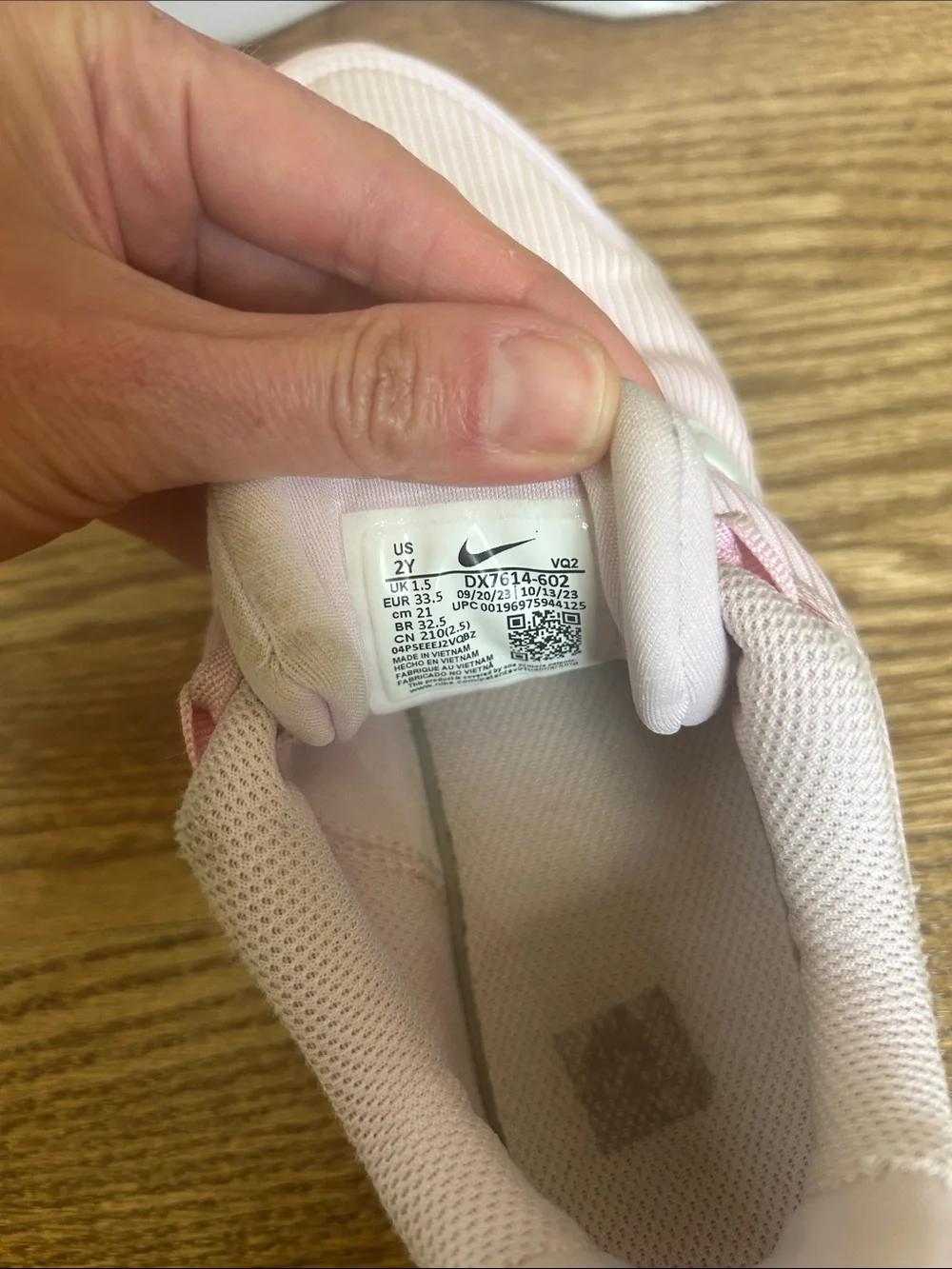 Kids Light Pink Nike Athletic Sneakers with White Swoosh